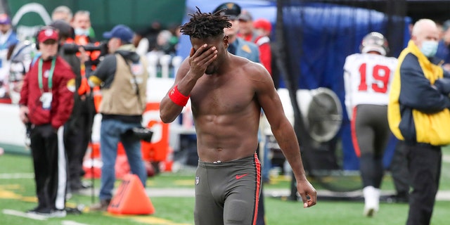 Tampa Bay Buccaneers wide receiver Antonio Brown wipes his face as he leaves the field after throwing his equipment into the crowd while his team plays offense during the third quarter of a game against the New York Jets Jan. 2, 2022 in East Rutherford Was staying  new Jersey 