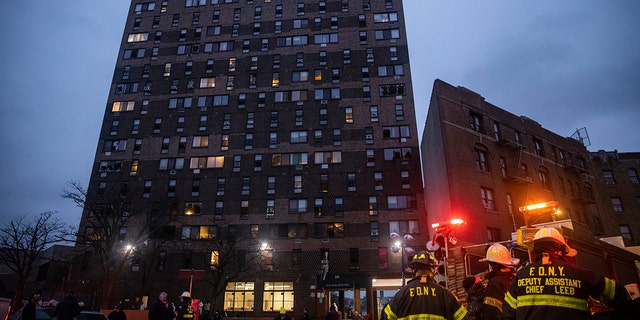 Emergency personnel work at the scene of a fatal fire at an apartment building in the Bronx on Sunday, Jan. 9, 2022, in New York.