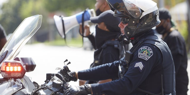 TEXAS, UNITED STATES - SEPTEMBER 26: Police officers take action as Black-led Second Amendment rights activists march in solidarity from the George Washington Carver Museum in Austin, Texas to the Texas State Capitol on September 26, 2020.