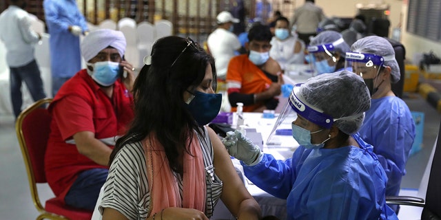 A woman receives a Sinopharm COVID-19 vaccine at the Guru Nanak Darbar Sikh Temple, in Dubai, United Arab Emirates, on Feb. 8, 2021.