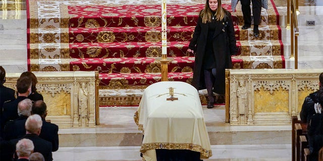 Dominique Rivera walks past her husband's casket after eulogizing him during his funeral mass at St. Patrick's Cathedral on Friday, Jan. 28, 2022. New York City Police Officer Jason Rivera and his partner, Officer Wilbert Mora, were fatally wounded when a gunman ambushed them as they responded to a family dispute last week. "You made me feel alive," his wife said during her heart-wrenching eulogy. "You <i>make</i> me feel alive."