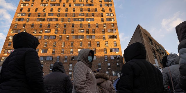 Residents of the apartment building which suffered the city's deadliest fire in three decades, gather outside the building to collect their belongings in the Bronx borough of New York on Monday, Jan. 10, 2022. 