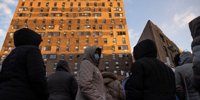 Residents of the apartment building which suffered the city's deadliest fire in three decades, gather outside the building to collect their belongings in the Bronx borough of New York on Monday, Jan. 10, 2022. 