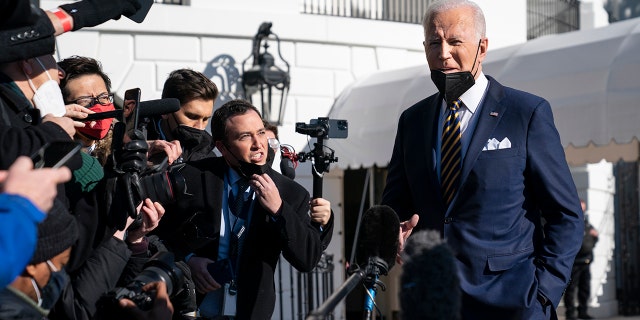 President Joe Biden talks to reporters