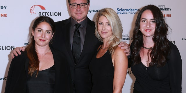 Saget poses with Rizzo and two of his daughters.