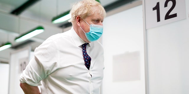 Britain's Prime Minister Boris Johnson visits a vaccination hub in the at Stoke Mandeville Stadium in Aylesbury, England, Monday Jan. 3, 2022, as the booster vaccination programme continues.