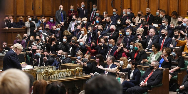 In this photo provided by Britain's Parliament, Britain's Prime Minister Boris Johnson speaks as members of the opposition party during the Prime Minister's Questions in the House of Commons in London, Wednesday, January 12, 2022. 