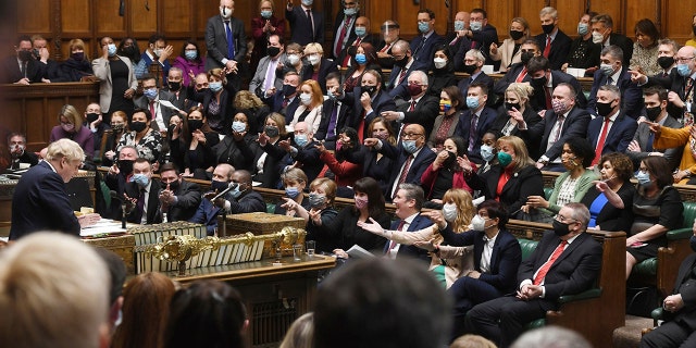 In this photo provided by Britain's Parliament, Britain's Prime Minister Boris Johnson speaks as members of the opposition party during the Prime Minister's Questions in the House of Commons in London, Wednesday, January 12, 2022. 