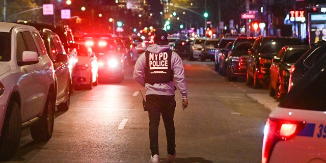 Police officers lock down the scene after two NYPD officers were shot in Harlem on January 21, 2022 in New York City.