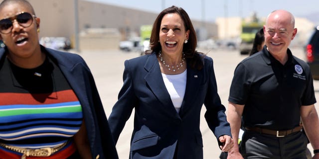 U.S. Vice President Kamala Harris walks with Department of Homeland Security (DHS) Secretary Alejandro Mayorkas and Spokesperson Symone Sanders to board Air Force Two at El Paso International Airport in El Paso, Texas, U.S., June 25, 2021. REUTERS/Evelyn Hockstein/File Photo