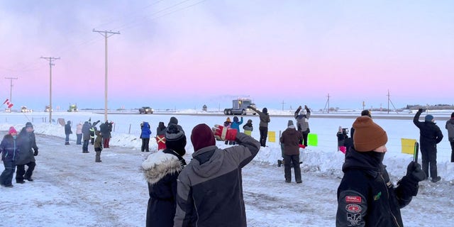 Family, friends and neighbours gather to show support for the freedom convoy on the Trans-Canada highway in Grenfell, Saskatchewan, Canada January 25, 2022 in this screenshot obtained from a video on social media. Mark Dimler/via REUTERS  THIS IMAGE HAS BEEN SUPPLIED BY A THIRD PARTY. MANDATORY CREDIT. NO RESALES. NO ARCHIVES.