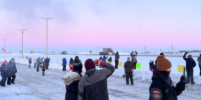 Family, friends and neighbors gather to show support for the freedom convoy on the Trans-Canada highway in Grenfell, Saskatchewan, Canada Jan. 25, 2022, in this screenshot obtained from a video on social media.
