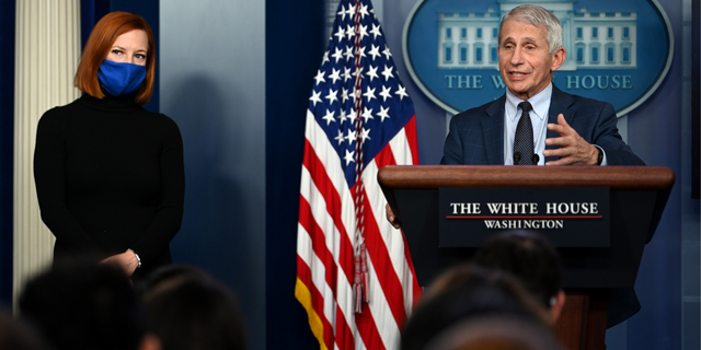 White House Press Secretary Jen Psaki (L) listens as director of the National Institute of Allergy and Infectious Diseases Anthony Fauci gives an update on the Omicron COVID-19 variant during the daily press briefing at the White House on December 1, 2021, in Washington, DC. (Photo by Chen Mengtong/China News Service via Getty Images)