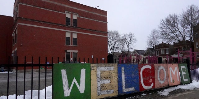 A sign on the fence outside of Lowell elementary school welcomes students on January 05, 2022 in Chicago, Illinois. Classes at all of Chicago public schools were canceled by the school district after the teacher's union voted to return to virtual learning, citing unsafe conditions in the schools as the Omicron variant of the coronavirus continues to spread.   (Photo by Scott Olson/Getty Images)