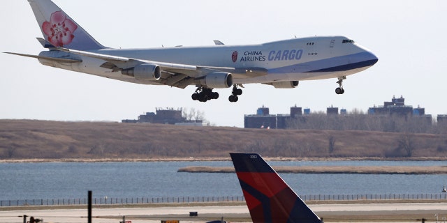 A China Airlines cargo jet lands at John F. Kennedy International Airport, Saturday, March 14, 2020, in New York. Verizon and AT&T have rejected a request by the U.S. government to delay the rollout of next-generation wireless technology.