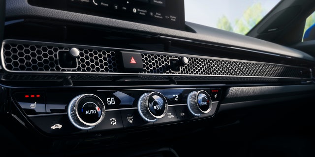 A metal grate hides the Honda Civic Hatchback's air vents.