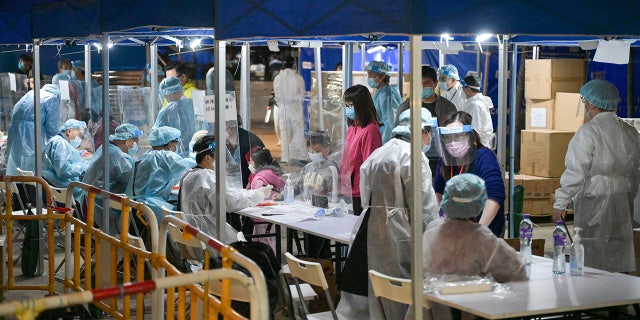 Residents register after receiving COVID-19 test at Tsui Ning Garden on January 4, 2022 in Hong Kong. (Photo by Chen Yongnuo/China News Service via Getty Images)