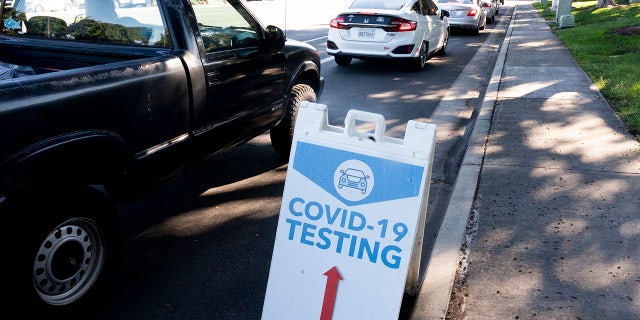 Jan. 3: Cars wait in line on Alton Parkway for a COVID-19 test at Kaiser Permanente in Irvine, California. (Photo by Paul Bersebach/MediaNews Group/Orange County Register via Getty Images)