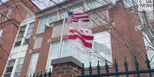The D.C. flag flies underneath the American flag.