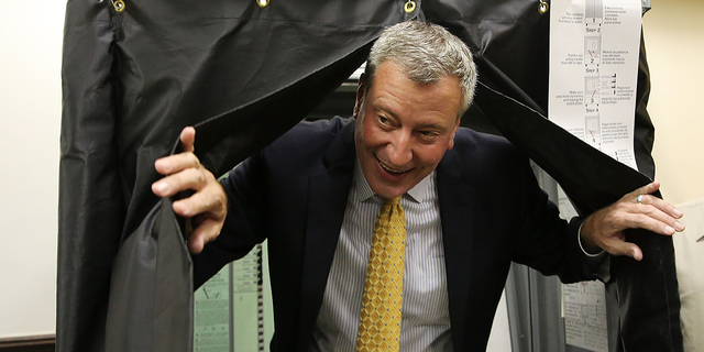 De Blasio emerges from a voting booth after voting in the New York City mayoral primary Sept.  10, 2013, in Brooklyn.