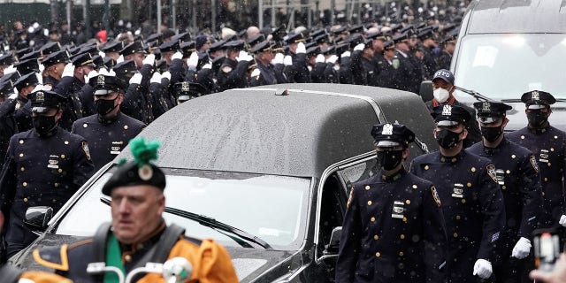 A hearse carries the casket during the Jan. 28, 2022, funeral service for New York City Police Department (NYPD) officer Jason Rivera, who was killed in the line of duty while responding to a domestic violence call.
