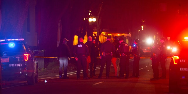 Eugene Police stand in the middle of Lincoln Street after  a shooting outside the WOW Hall in Eugene Friday night.Eug 011422 Shooting 03