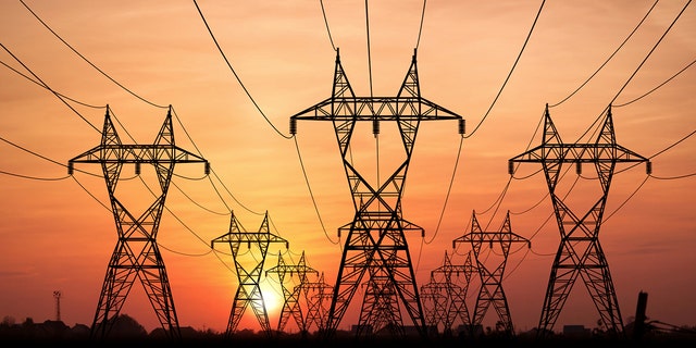 Electricity Pylons at sunset on background