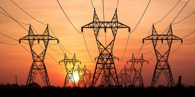 Electricity Pylons at sunset on background