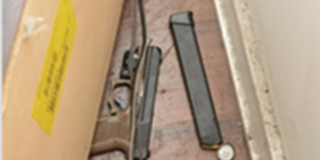 A firearm with an extended magazine was recovered in a nearby residence.