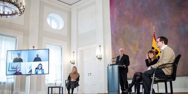 German President Frank-Walter Steinmeier, at the speaker's desk, attends a discussion on the pros and cons of compulsory vaccination to overcome the Covid 19 pandemic in Germany with guests, as well as digitally connected participants, at the Bellevue Palace in Berlin, Germany, Wednesday, January 12, 2022.
