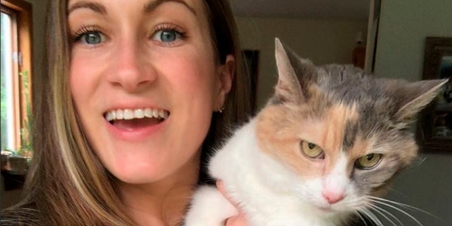 Angela Rafuse and her cat, Mackenzie, at home in Chester, Nova Scotia, Canada, in July 2021.