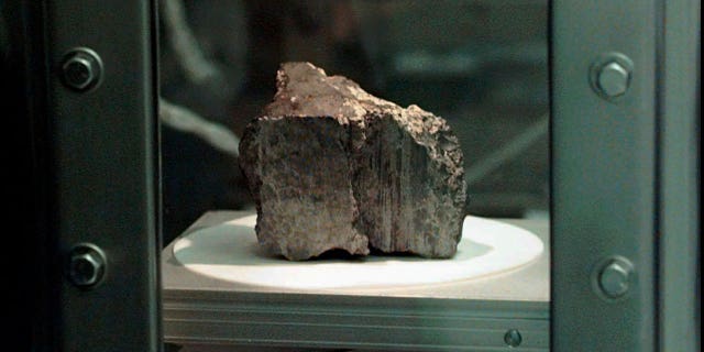 The meteorite labeled ALH84001 sits in a chamber at a Johnson Space Center lab in Houston, Aug. 7, 1996. (AP Photo/David J. Phillip)