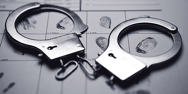 Handcuffs on top of a fingerprint form.