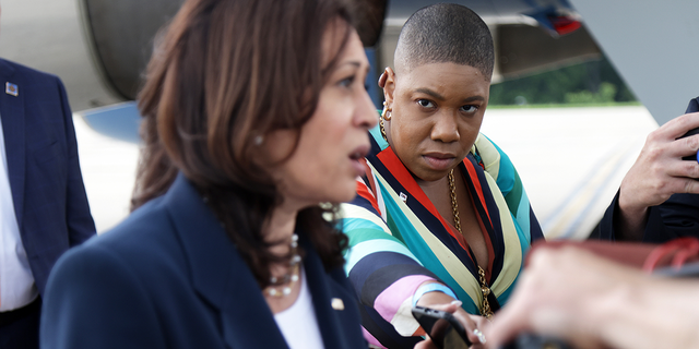 Vice President Kamala Harris speaks to members of the press as Symone D. Sanders looks on at Greenville-Spartanburg International Airport in Greer, South Carolina, before she boards Air Force Two to return to Washington June 14, 2021.