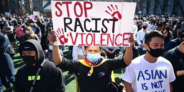 Members and supporters of the Asian-American community attend a "rally against hate" at Columbus Park in New York City on March 21, 2021. - Three massage parlors around Atlanta were targeted March 16, 2021, and a 21-year-old suspect was arrested. Robert Aaron Long faces eight counts of murder and one charge of aggravated assault.