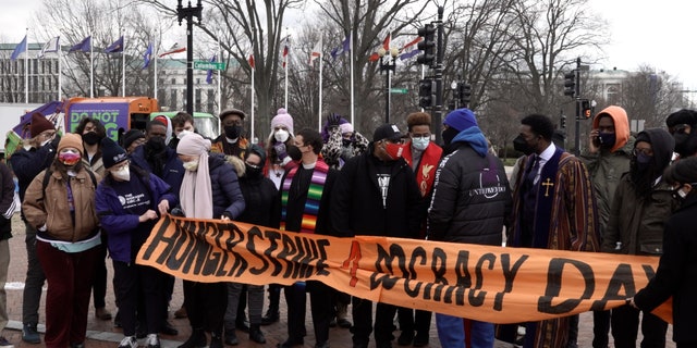 Hunger strikers hold 'Hunger Strike 4 Democracy' sign