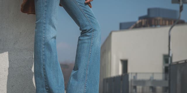 Detail photo of a girl wearing flared jeans.