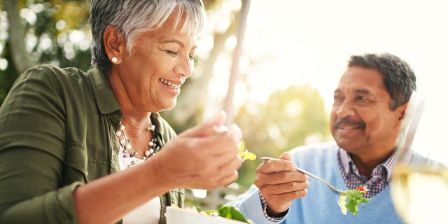 Happy older couple eating