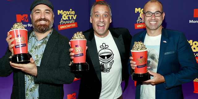  In this image released on May 17, (L-R) Brian Quinn, Joe Gatto, and James Murray, winners of Best Comedy / Game Show for "Impractical Jokers", pose backstage during the 2021 MTV Movie &amp; TV Awards: UNSCRIPTED in Los Angeles, California.