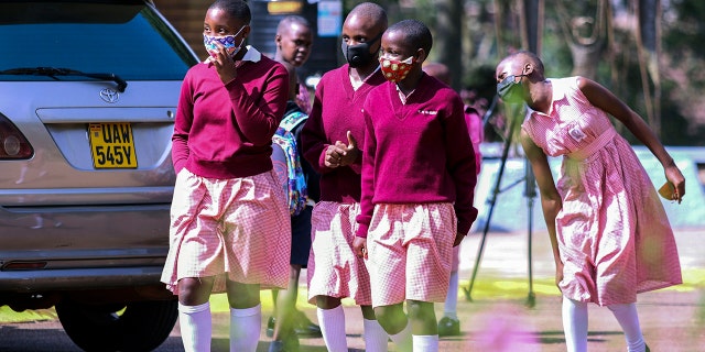 Students walk around the school grounds during recess at Kitante Primary School in Kampala, Uganda, Monday January 10, 2022.