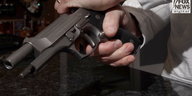 A man racks a firearm.