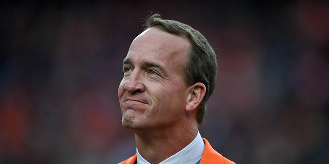 Former NFL quarterback Peyton Manning looks on during a ceremony to reveal his name on the stadium Ring of Fame at Empower Field at Mile High in Denver, Oct. 31, 2021.