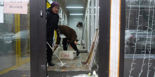 Vendors clean up their store which was robbed and looted during clashes in Almaty, Kazakhstan.