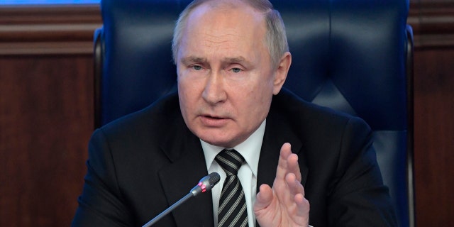Russian President Vladimir Putin gestures while speaking at an extended meeting of the Russian Defense Ministry Board at the National Defense Control Center in Moscow, Russia, Dec. 21, 2021.