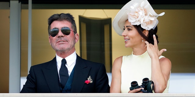  Simon Cowell and Lauren Silverman watch the racing as they attend day 1 of Royal Ascot at Ascot Racecourse on June 15, 2021 in Ascot, England. 
