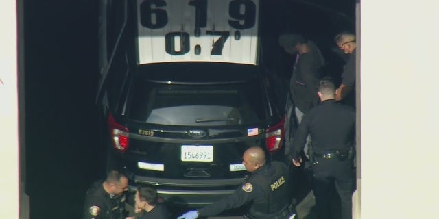 Aerial images obtained by FOX 11 Los Angeles show police putting him into the back of a police SUV ahead of his expected transfer to LAPD custody.