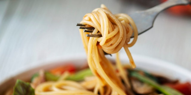 Spaghetti is swirled onto a fork. Try whole-grain pasta choices as part of a heathy diet. 