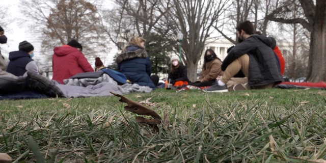 Hunger strikers sit on sleeping bags outside the U.S. Capitol