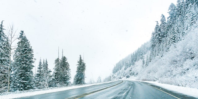 Empty road with snow covered landscape in winter season