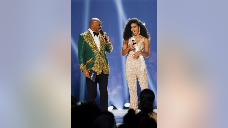 Host Steve Harvey reacts to a joke by Miss USA Cheslie Kryst during the Miss Universe pageant at Tyler Perry Studios in Atlanta, Georgia, Dec. 8, 2019. 